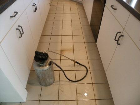 Pre-soaking dirty tile and grout - the cleaning process in progress